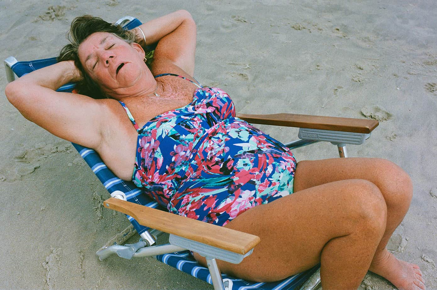 woman sleeping in a beach chair